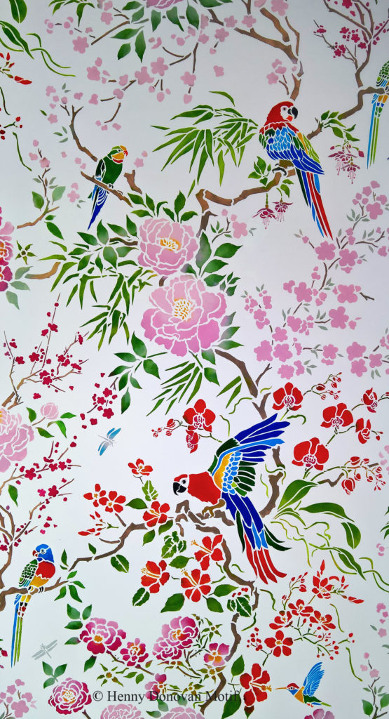 NEW! Stunning Chinoiserie All-Over Stencil
Innovative drop-repeat design of Parrots, Peonies, Roses, Blossom and more...
The Parrot & Peony Chinoiserie All-over Stencil will allow you to create hand-printed wallpaper effects with tropical birds and chinoiserie style flowers and foliage and takes repeat stencilling and chinoiserie design to a whole new level! Exciting artwork for walls and fabric, with a multitude of motifs. Exotic macaw parrots, cockatoo and parakeets sit amongst profusely flowering branches of oriental peonies, full blown roses and blossom sprays, with orchid, hibiscus, bamboo and fuchsia, flying humming bird, dragonflies and butterfly!  All carefully woven into an innovative drop repeat, which extends the size of the repeated area and creates a magical, enchanting all-over pattern effect.

This is achieved on two large detailed sheets, working on a chequer-board layout with registration dots for aligning each successive repeat. Also with third sheet of details and extra motifs. Advanced stencil - see size and layout specifications below. Comes with full step by step instructions.  See the Parrot and Peony Chinoiserie Panel Stencil version of this design.