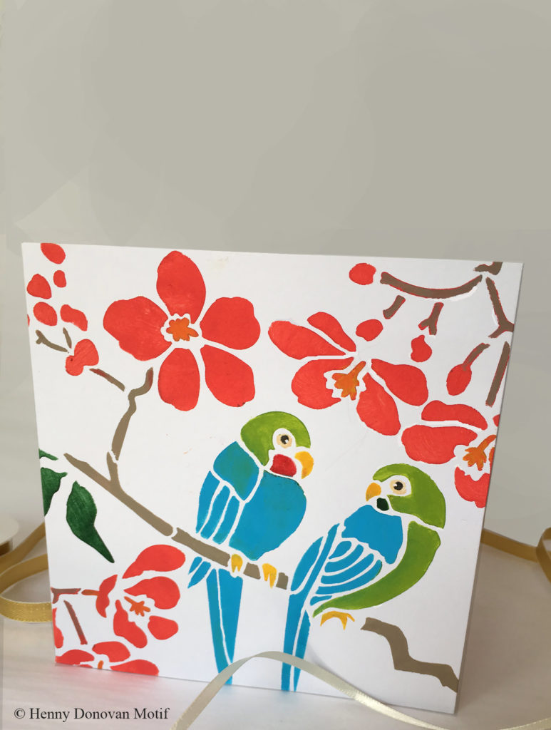 NEW! Lovebirds Stencil
Charming little love birds and exotic flowers.
This stencil depicts wonderful little lovebirds chatting together on a branch of small exotic flowers. This delightful mini stencil is perfect for adding pops of pattern and colour to all sorts of clothing, home accessories and furniture as well as making your own perfect greeting card. This design is one motif from our Parrot and Peony Chinoiserie All-Over Stencil.

Small single sheet stencil- see size and layout specifications below.